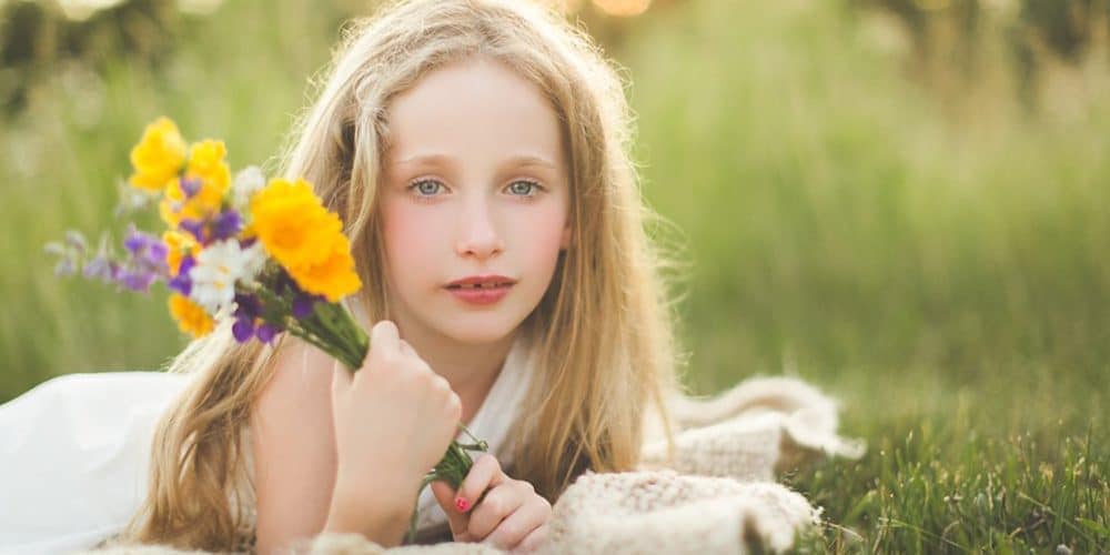 Photo of a girl holding flowers in Ashburn, VA by photographer Rebecca Danzenbaker